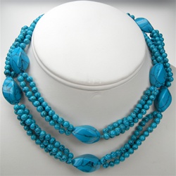 Beautiful Endless Synthetic Turquoise Necklace. 19x12mm twisted beads alternating with 3-rows of 4mm beads. Necklace is 30" long.