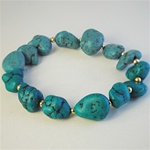 Wholesale Genuine Turquoise Bracelet Fabulous turquoise nuggets with gold tone bead accents, on a stretch bracelet.