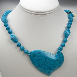 Beautiful Synthetic Turquoise Necklace. 19x12mm twisted beads alternating with 8mm beads, knotted. Unique 64x50mm ornament. Necklace is 30" long
