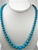Beautiful Synthetic Turquoise Necklace. Graduated round beads are 6mm-16mm in size. Necklace is 24 inches long with silver plated clasp